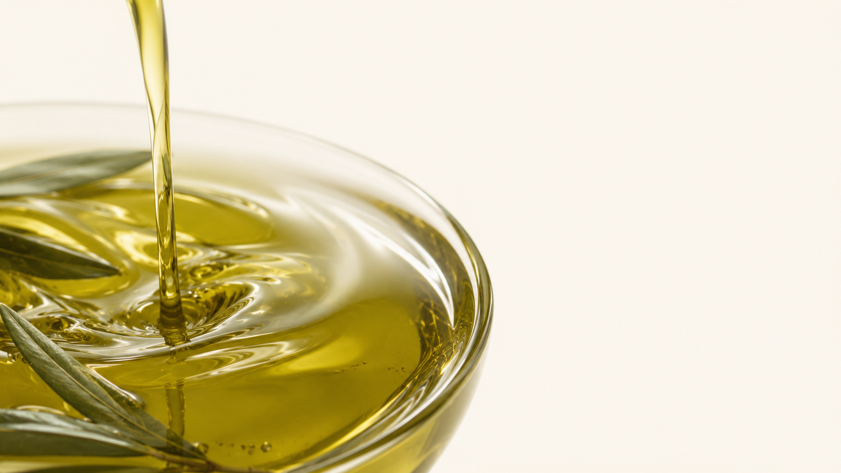 A slow golden swirl of extra virgin olive oil